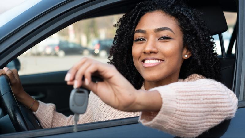Female driver holding keys